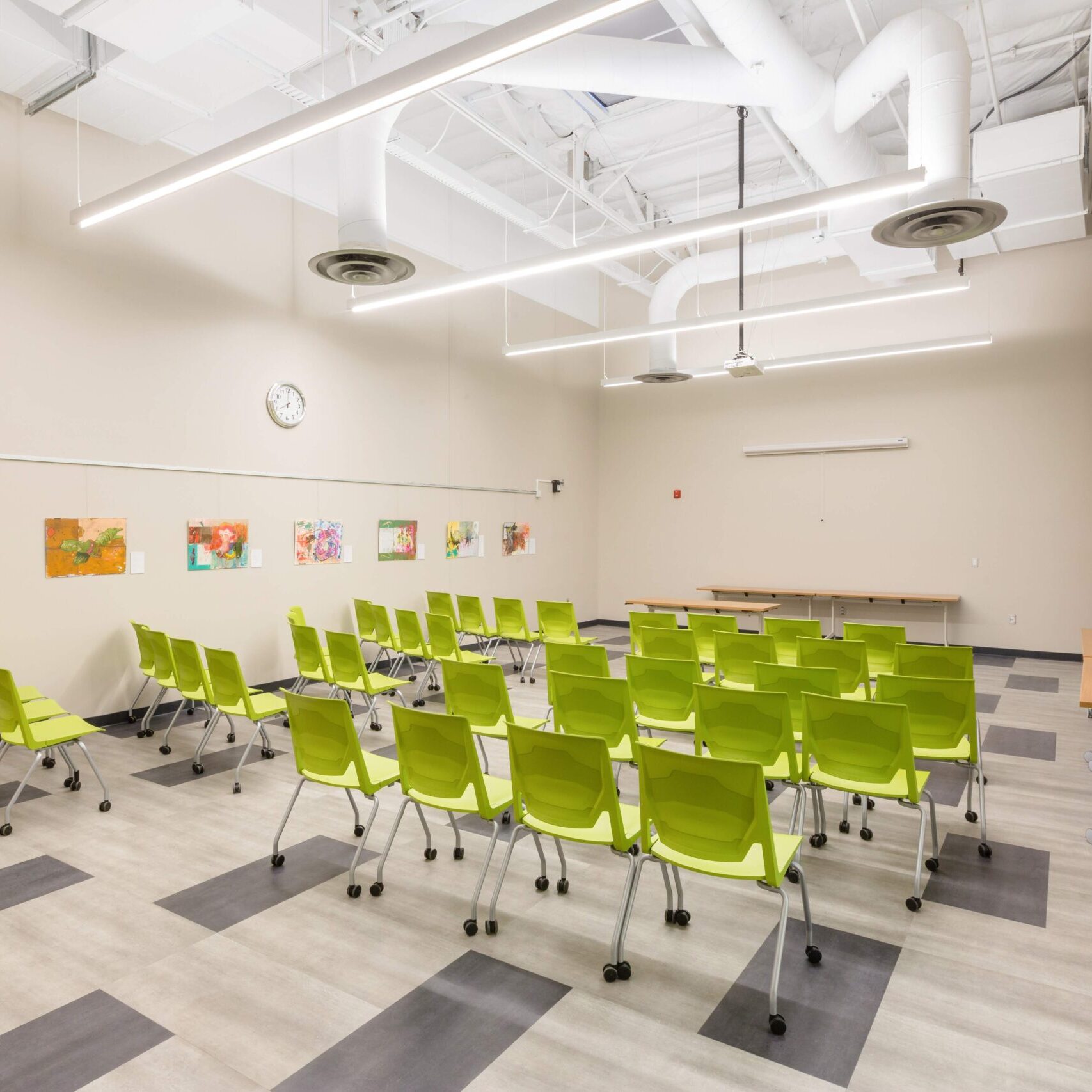 interior of betty rodriguez library with green cheers facing the front of a small classroom that is brightly lit and open spaced