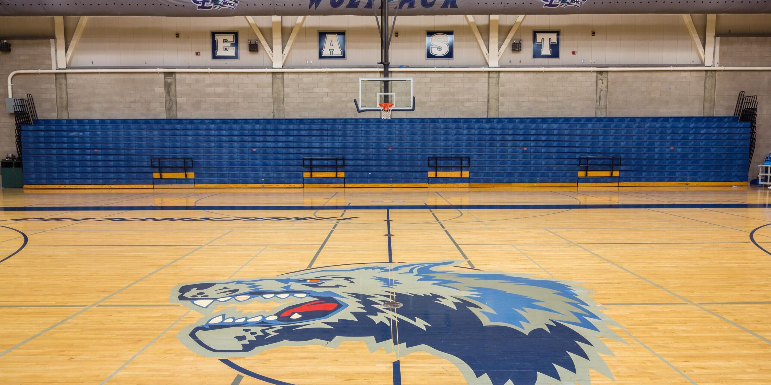 close up up the Clovis East Wolves mascot in the center of the basketball court for clovis east