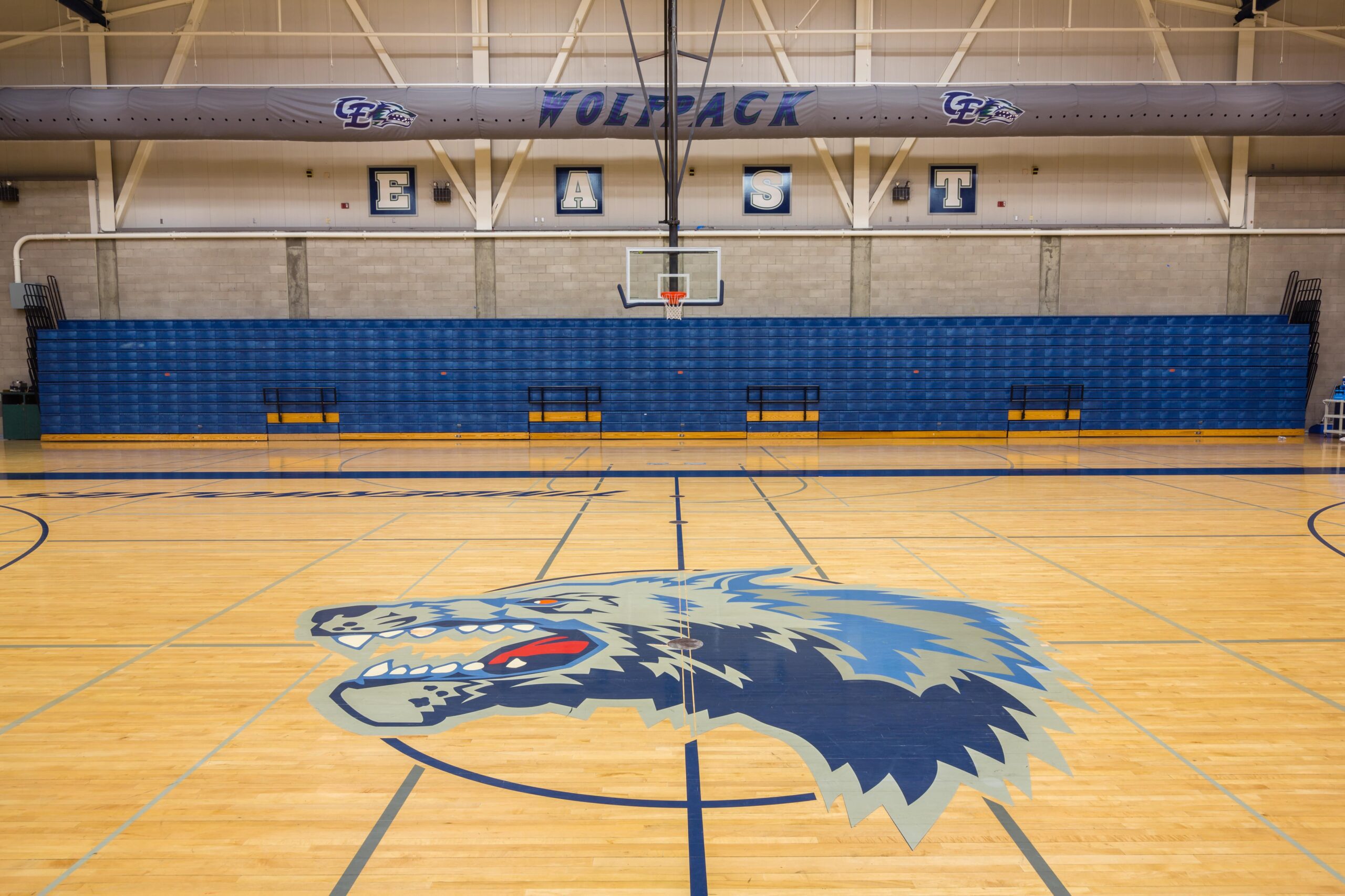 close up up the Clovis East Wolves mascot in the center of the basketball court for clovis east