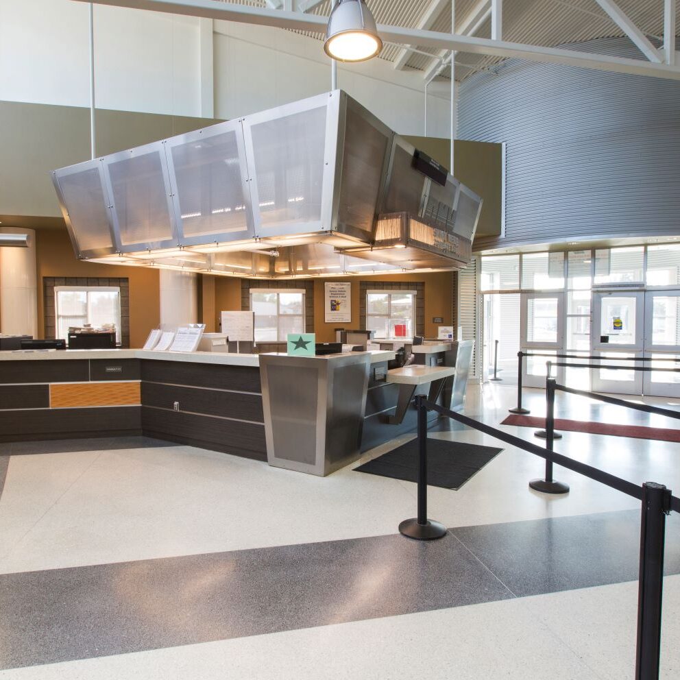 interior shot of the department of motor vehicles building in clovis showing the service desk with roped lines in a clean fashion during daytime hours and exposed lighting for ambiance